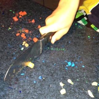 Mr 8. Cutting the crayons into smaller pieces.