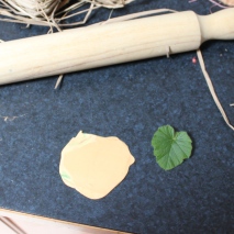 Roll over bake clay out to desired thickness. Press leaf into clay and roll again. Remove leaf and cut out leaf shape