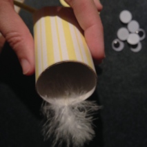 Attach the head feather to the inside of the top of the roll before folding it in.